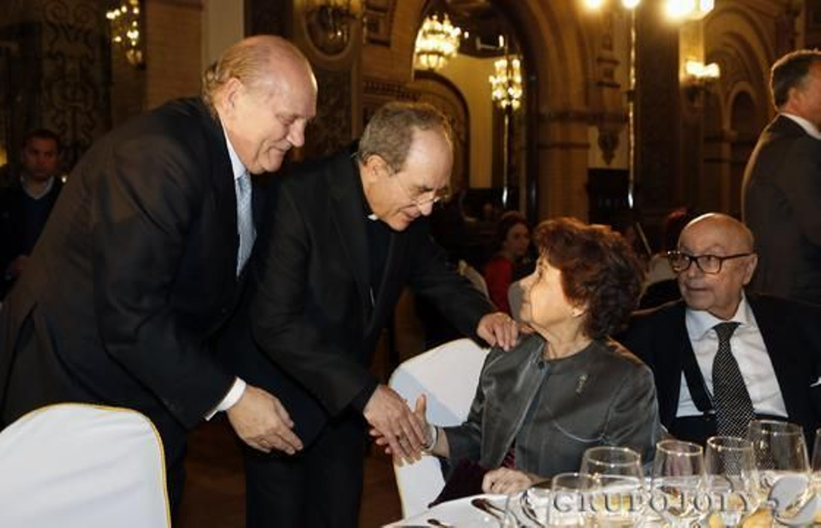 El arzobispo de Sevilla, Juan José Asenjo, saluda a Carmen Laffón en presencia de José Moya y Manuel Clavero.