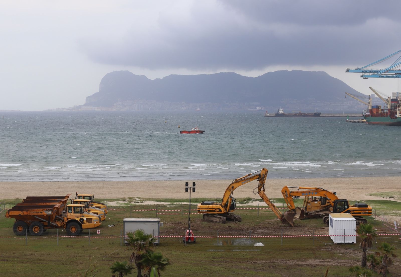 La maquinaria pesada, lista para el trasvase de arena en El Rinconcillo, este lunes.