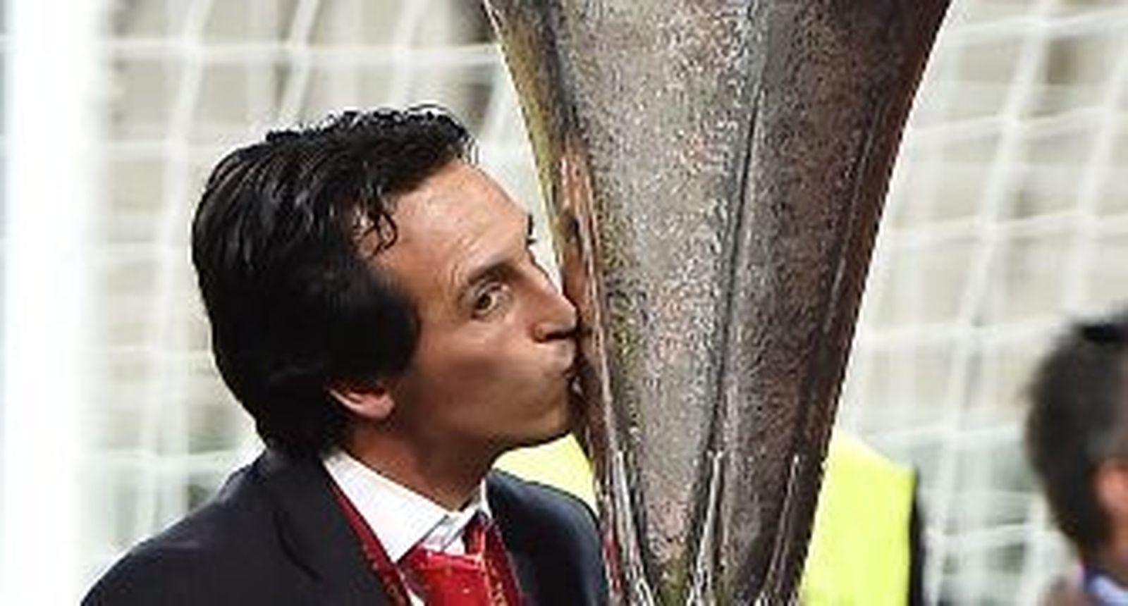 Emery besa el trofeo de la Liga Europa logrado en Turín. / EFE