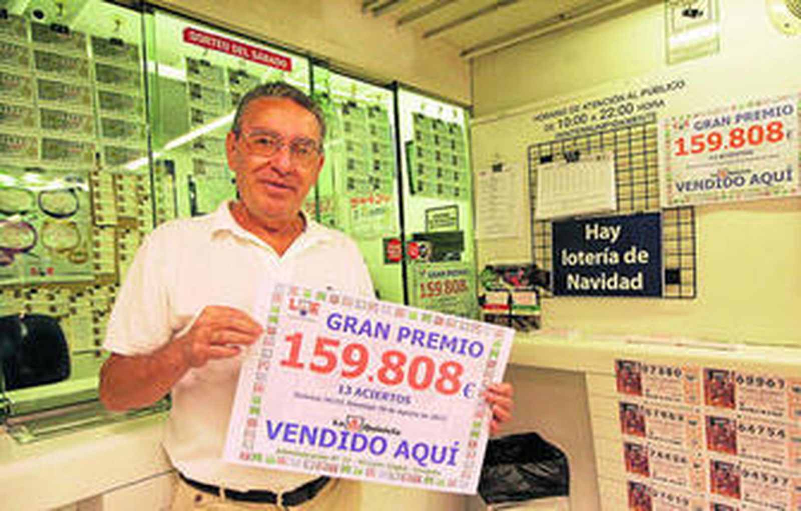 Pedro Romero sostiene el cartel que indica la suma que ha repartido su administración.