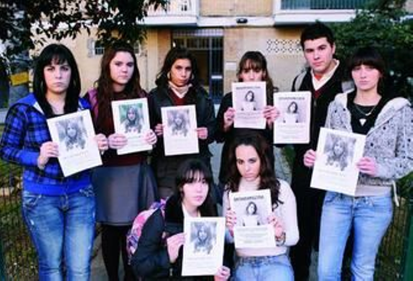 Compañeras y amigas de Marta del Castillo muestran carteles con su fotografía y su descripción, ayer en el barrio de la joven.