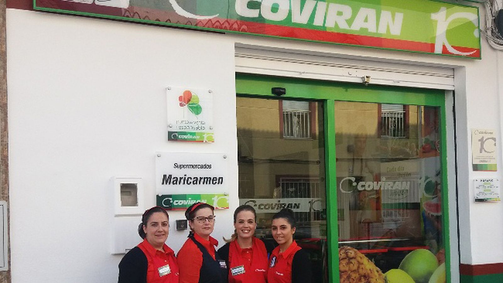 Socias de Covirán frente a un supermercado