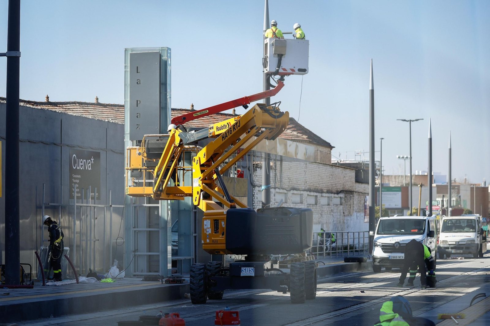 Operarios trabajando en la marquesina de la parada La Paz de Churriana