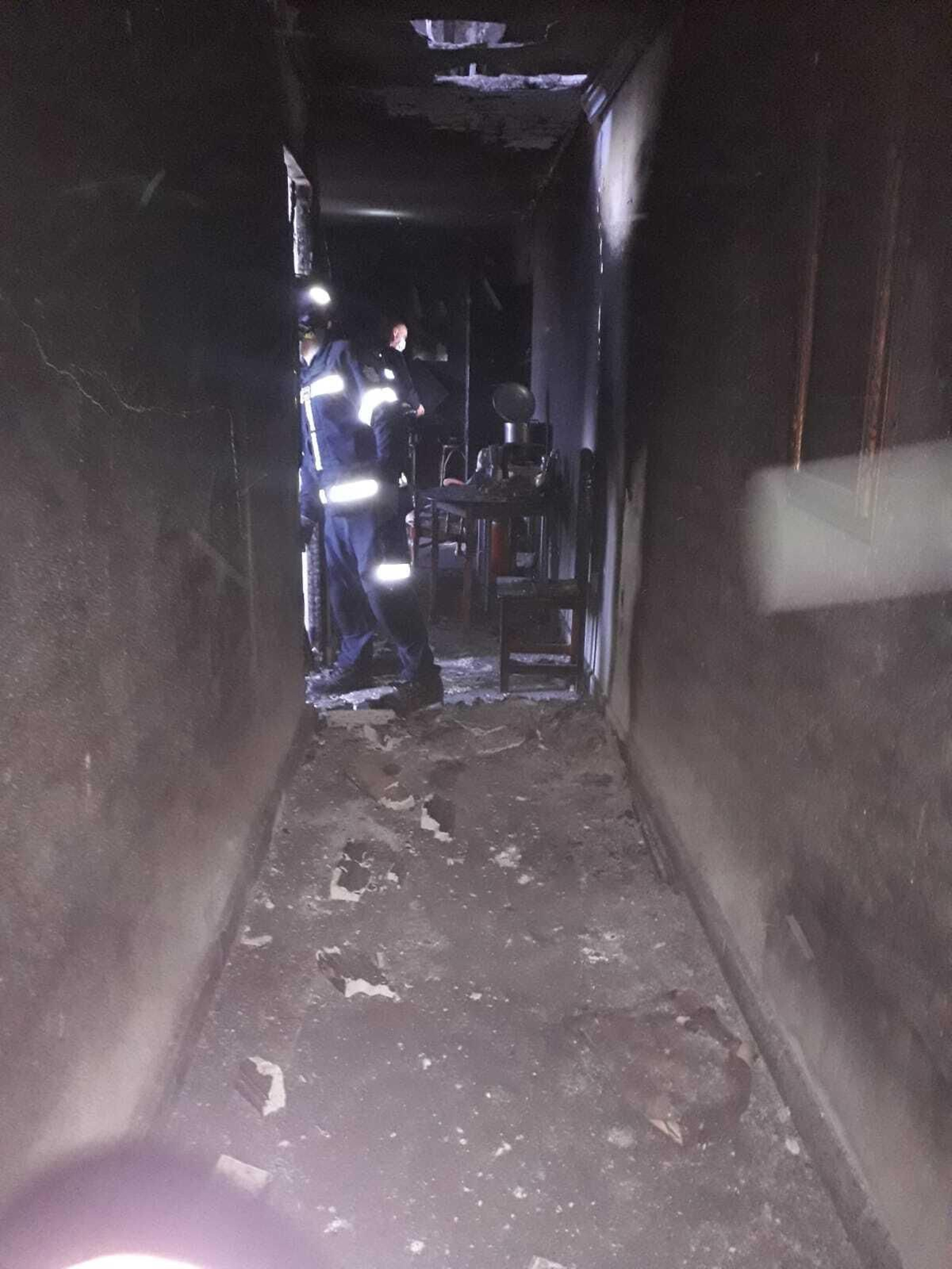 Bomberos interviniendo en la vivienda incendiada en Barbate