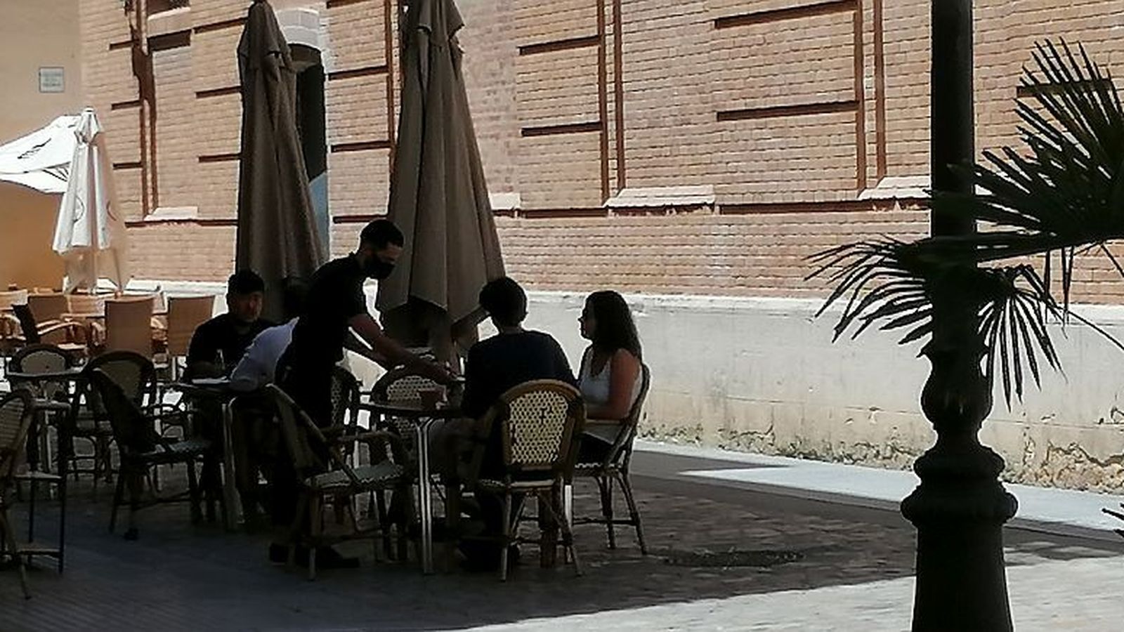 Un camarero entrega la cuenta en una terraza de Cádiz.