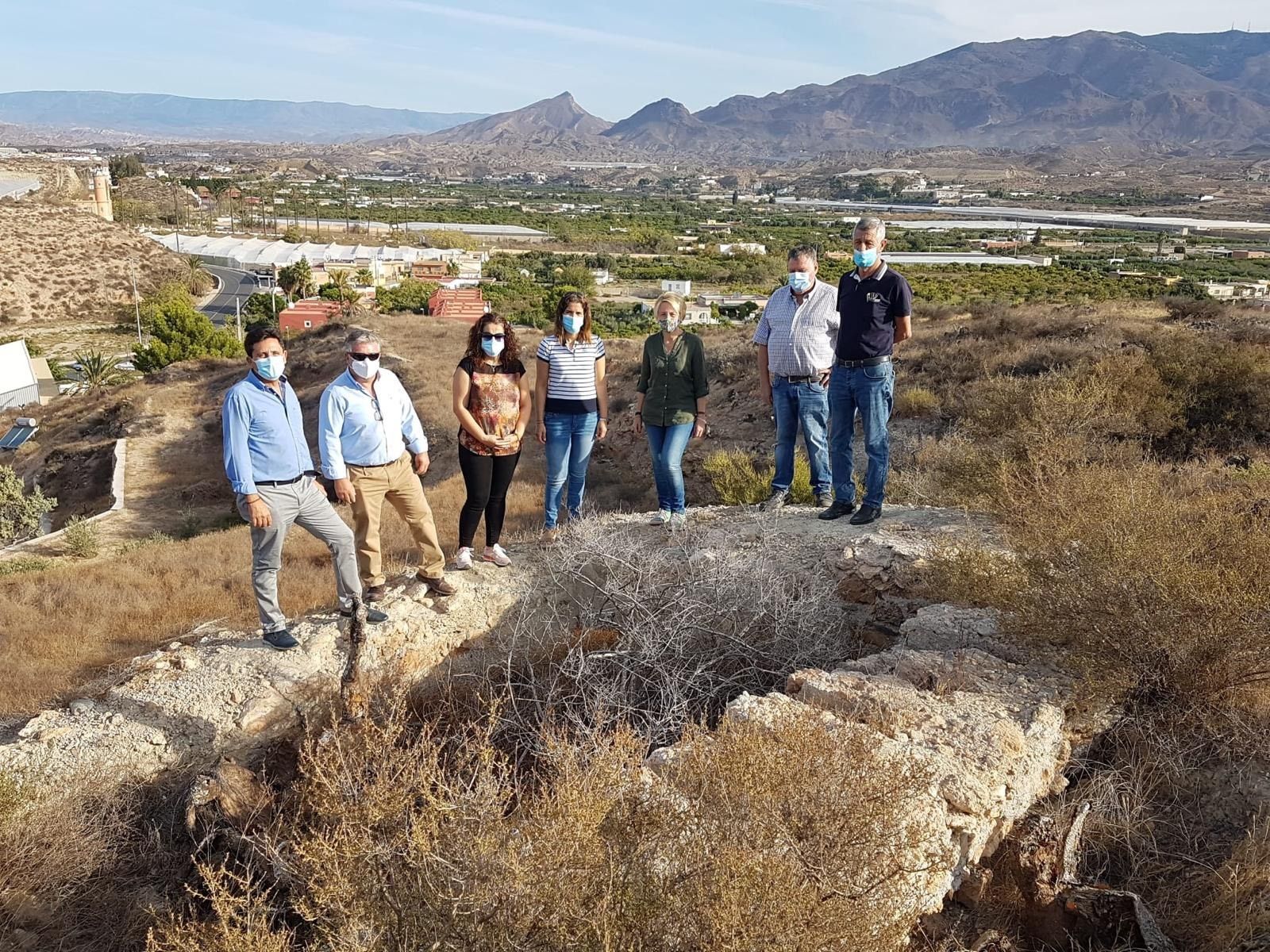Autoridades junto a los restos de una antigua vivienda.
