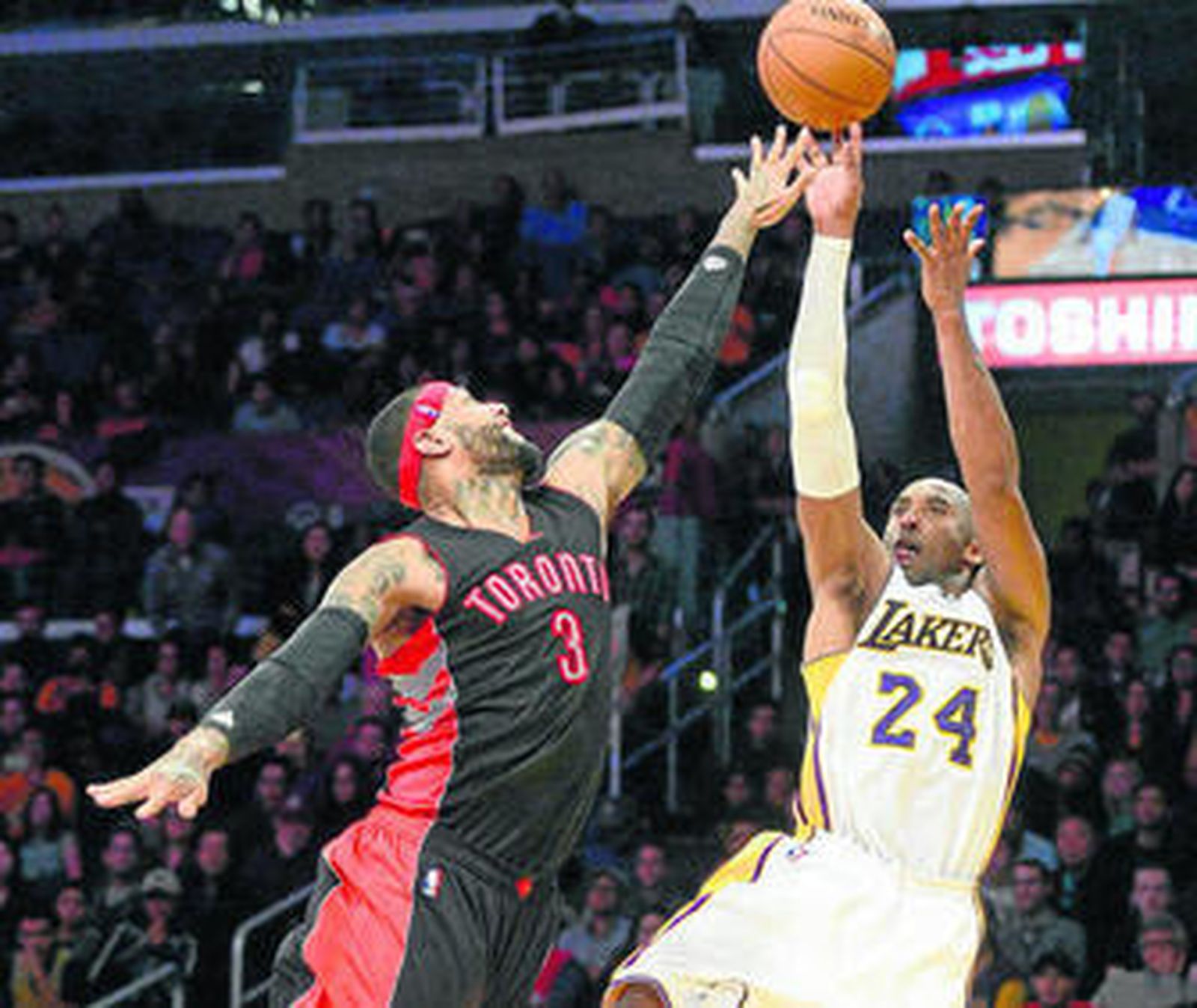 Kobe Bryant lanza ante la defensa de James Johnson.