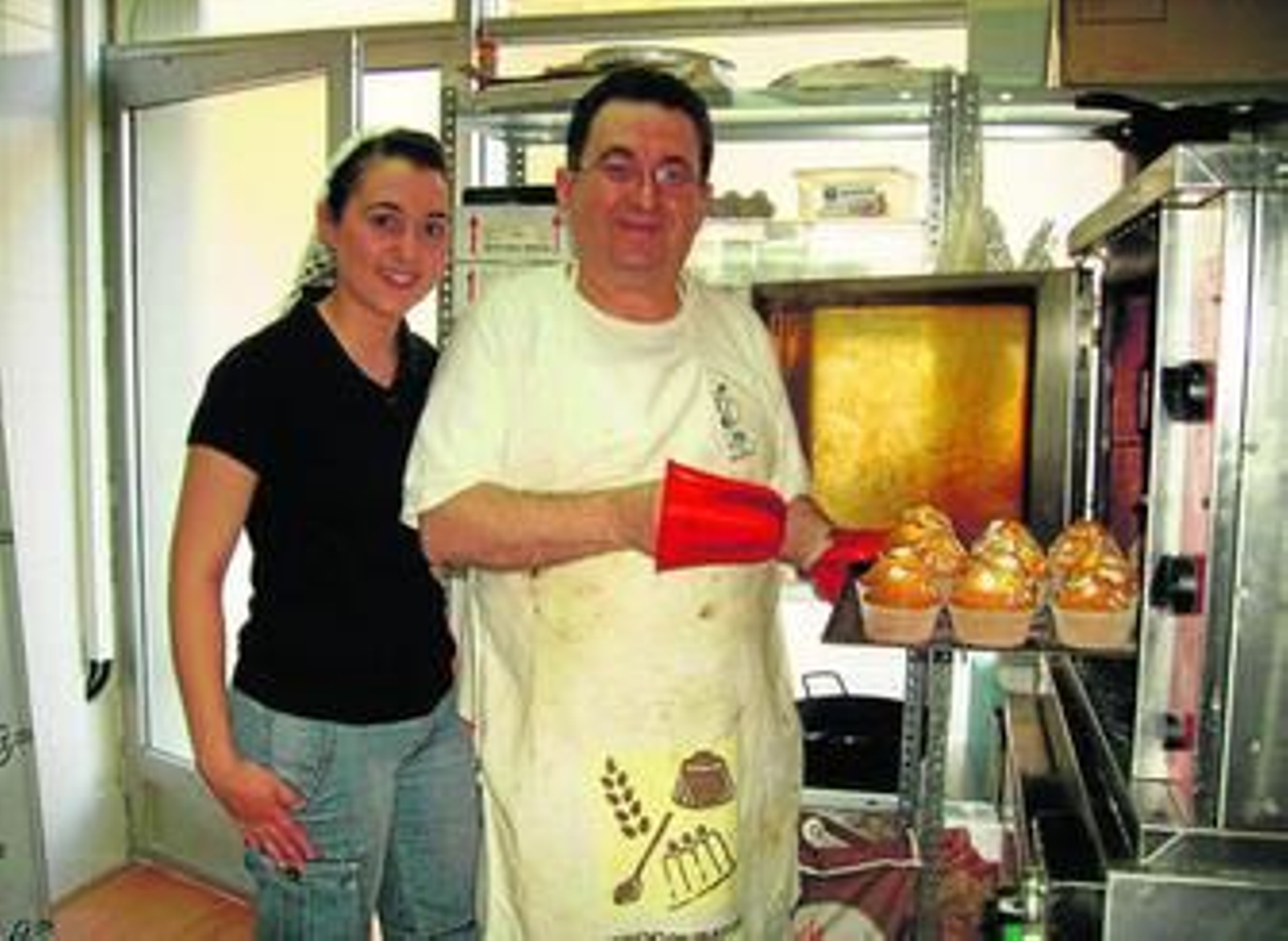 Andrés Soler y su hija Azahara sacan del horno algunas magdalenas.