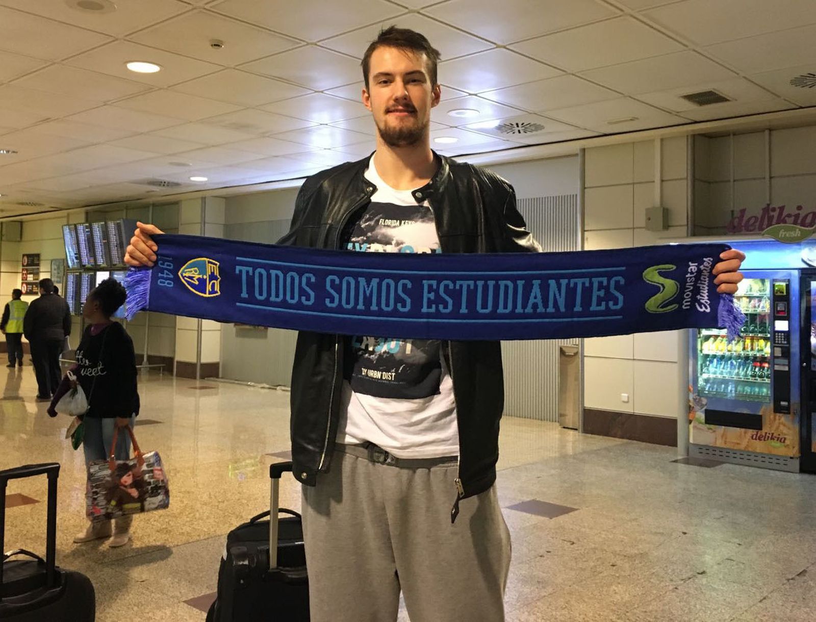 Balvin, ex jugador del conjunto hispalense, posa en el aeropuerto de Madrid con la bufanda de Estudiantes.