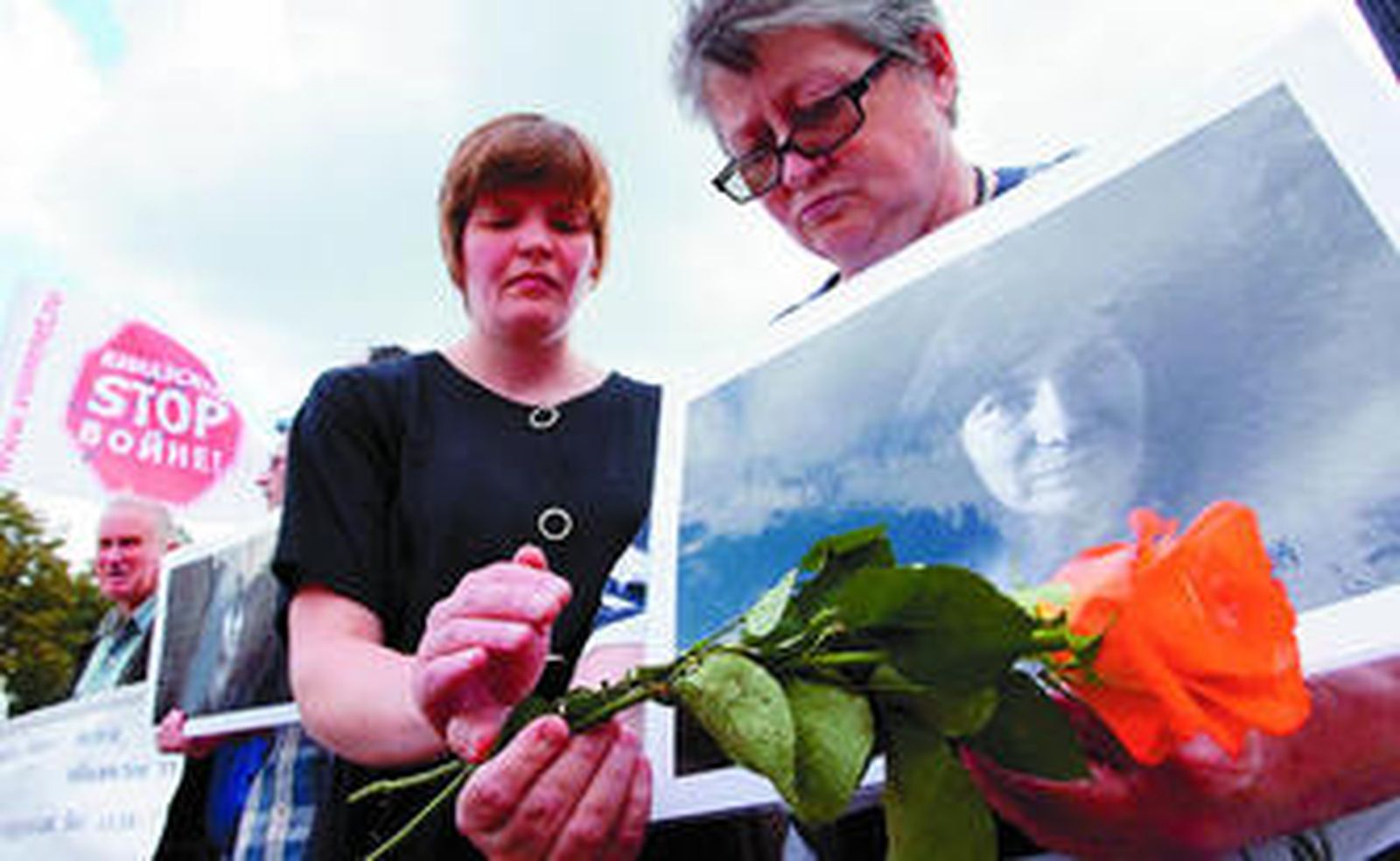 Varias personas sostienen fotografías de la activista Natalia Estemirova durante una manifestación por su asesinato en Moscú.