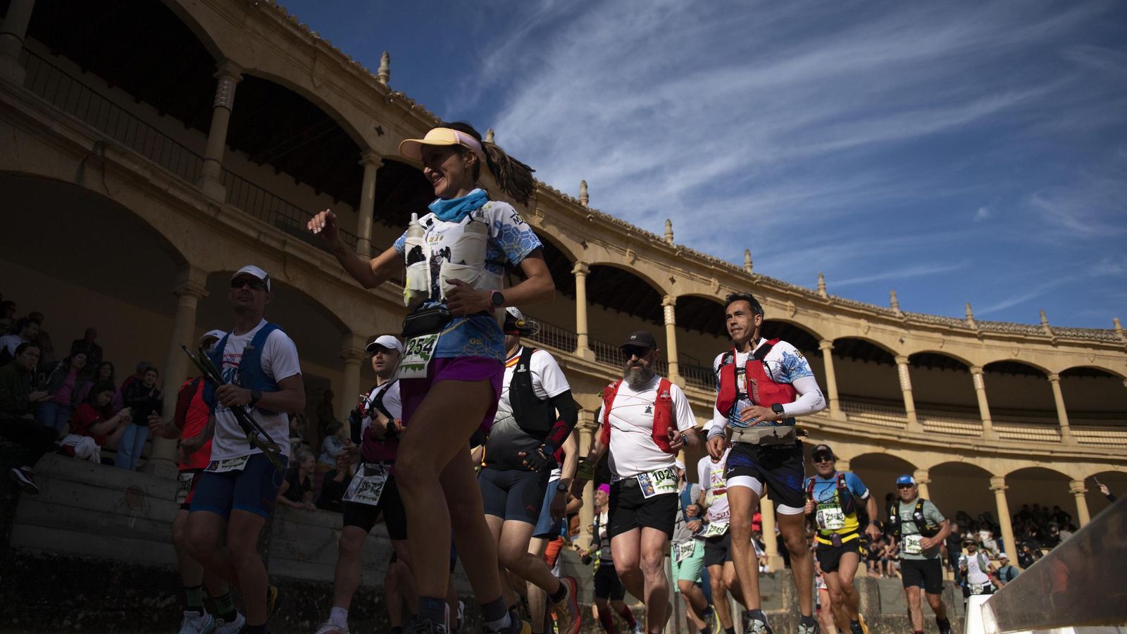 Marchadores pasando por el interior de la plaza de toros de Ronda.
