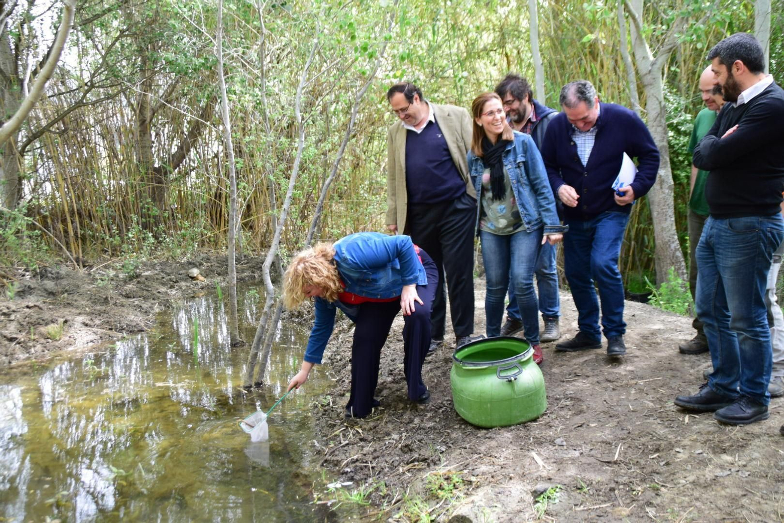 La alcaldesa de Motril, Flor Almón, participando en la reintroducción de los peces en la charca.