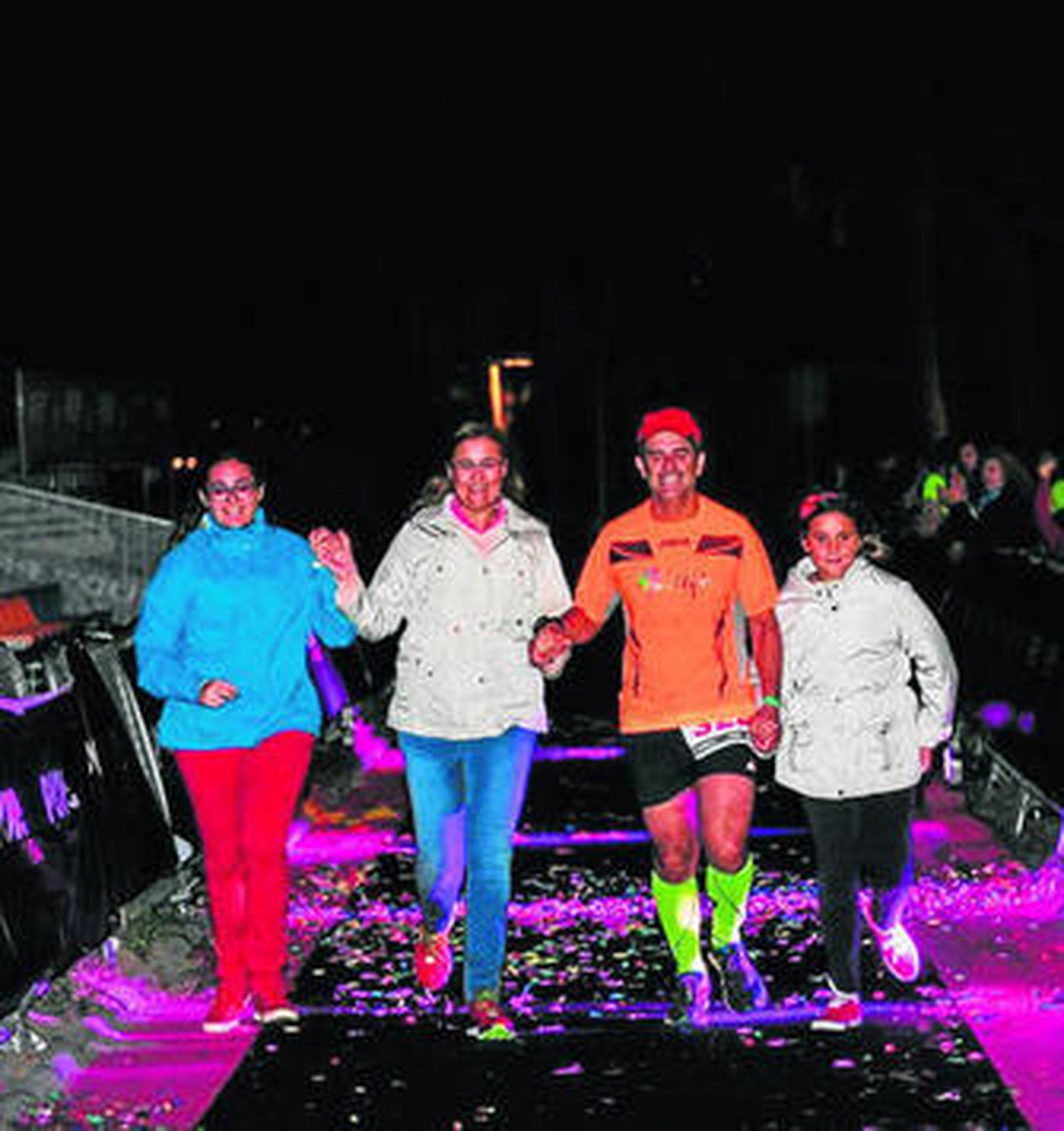 Antonio Ríos cruza la línea de meta acompañado por su familia.