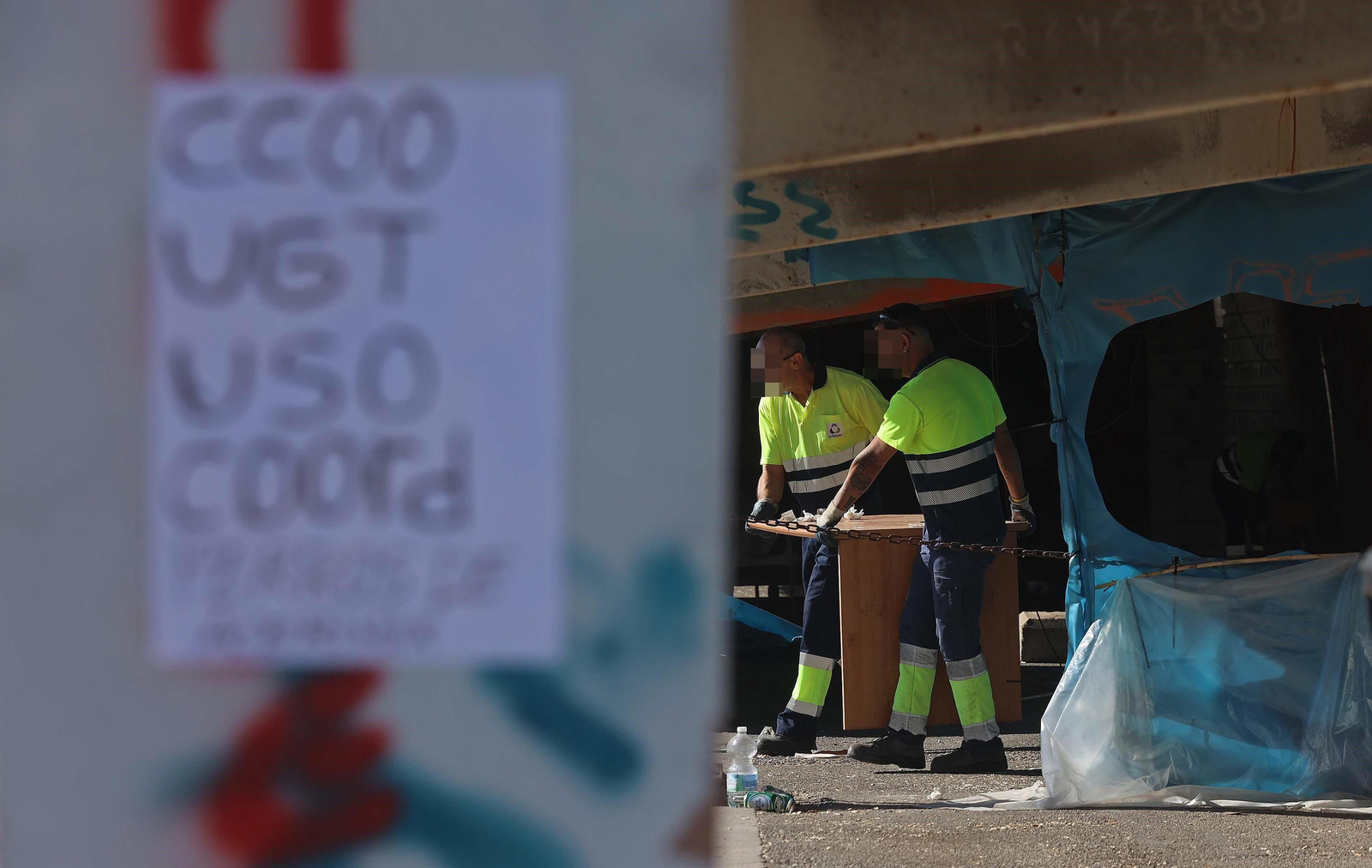 Trabajadores limpian las instalaciones antes del inicio de la actividad en la fábrica de Palmones.