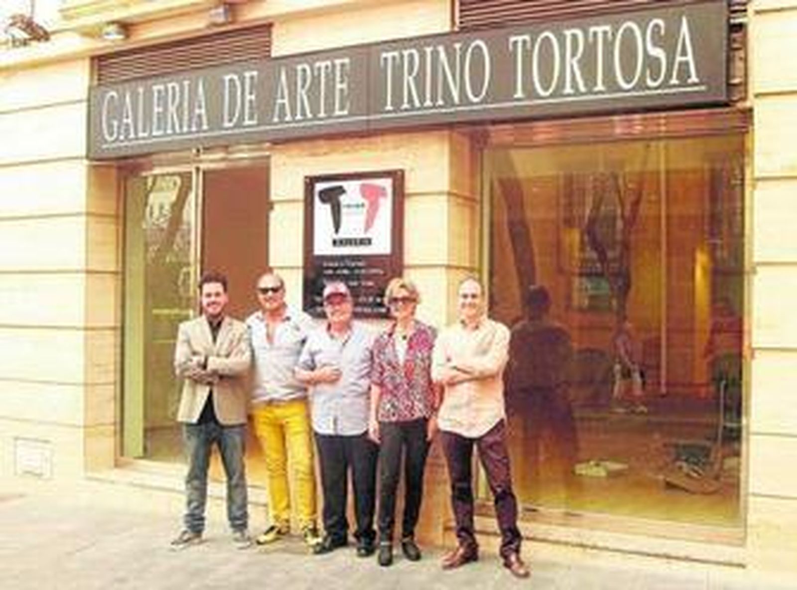 El artista con su familia y el propietario de la galería, que ayer ultimaba los detalles, Trino Tortosa.
