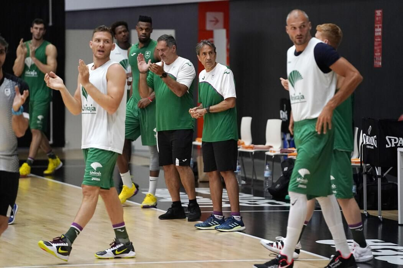 Los jugadores y técnicos del Unicaja aplauden tras un entrenamiento en Valencia.