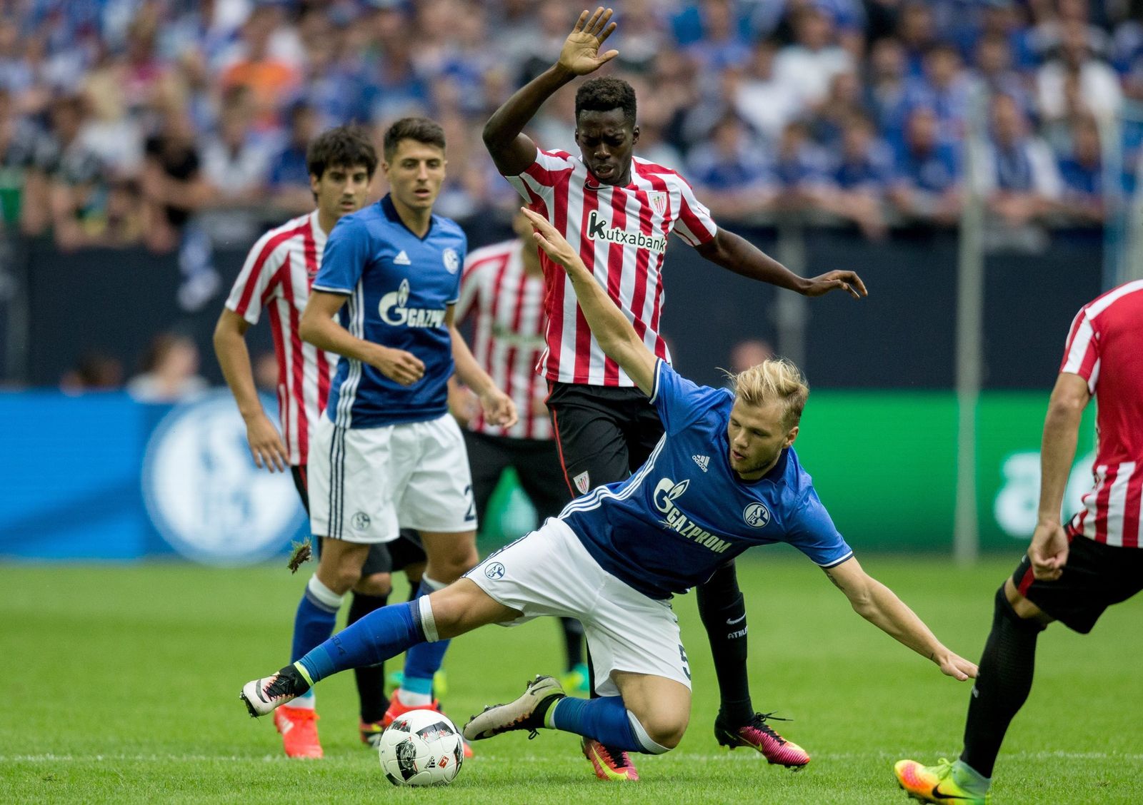 Johannes Geis se tira al suelo para interceptar un avance de Iñaki Williams durante un Schalke 04-Athletic de Liga Europa.