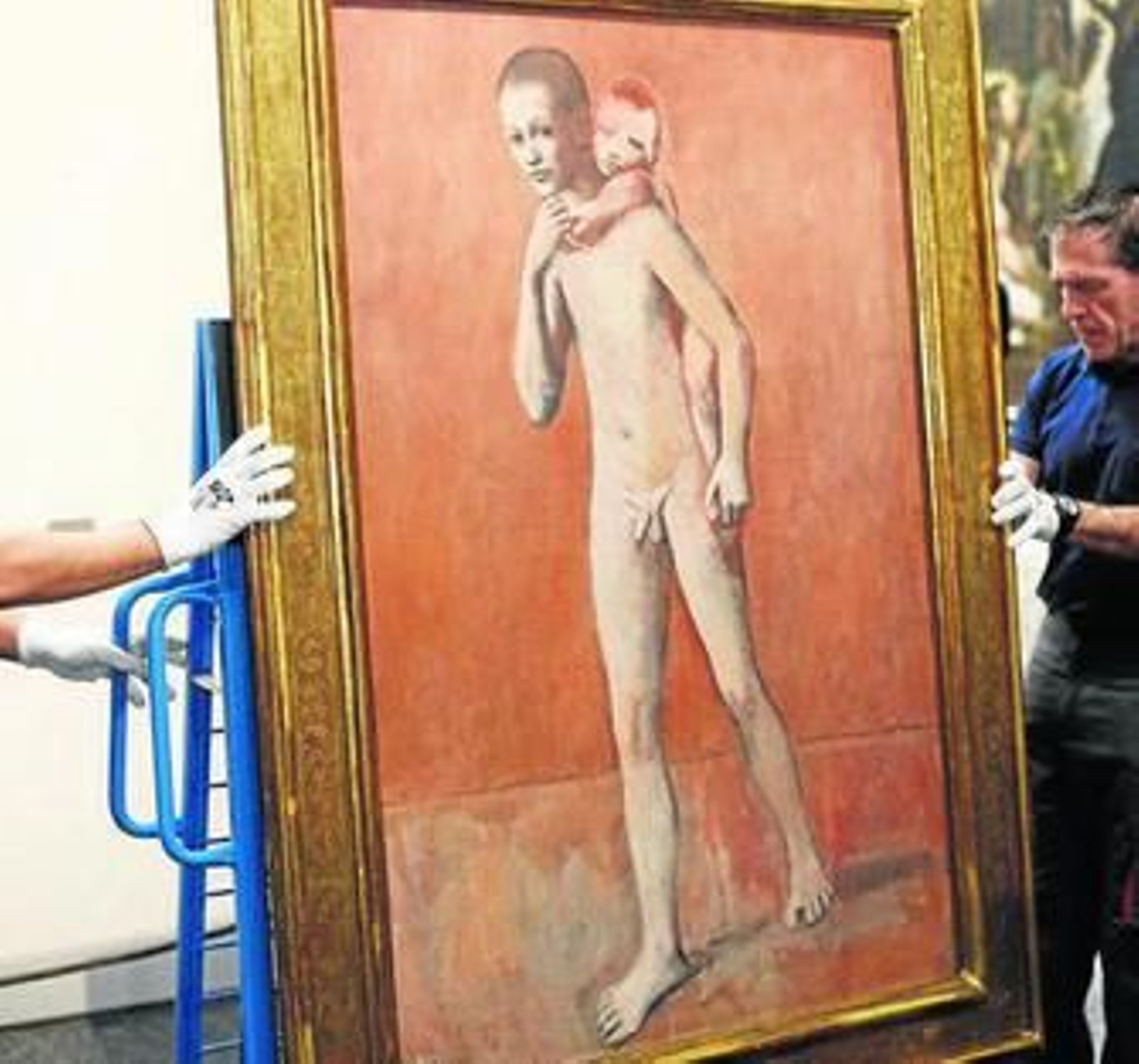 Dos operarios proceden a colgar 'Los dos hermanos', ayer, en el Prado.