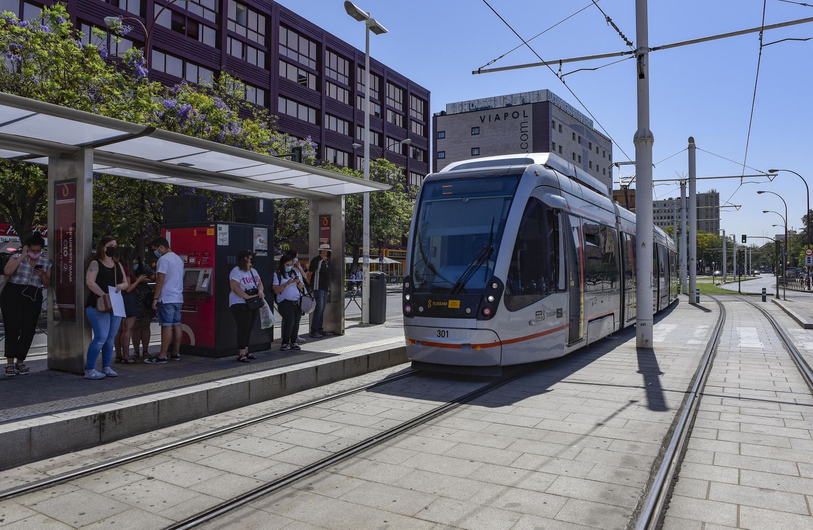 Viajeros esperando en la parada del tranvía de San Bernardo.