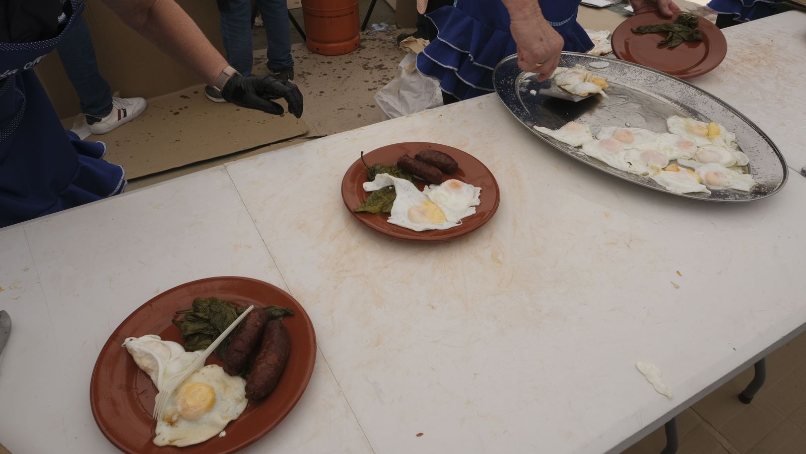 Imágenes de la degustación de huevos fritos con chorizo, en las Fiestas de Santa María del Águila
