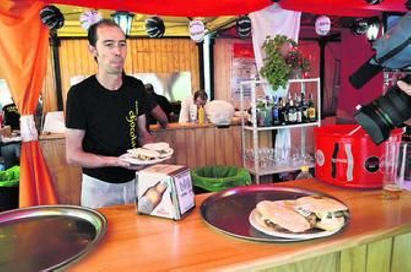 Un camarero del bar Dame Chocolate de Albolote sirviendo una de sus tapas seleccionadas para este evento.