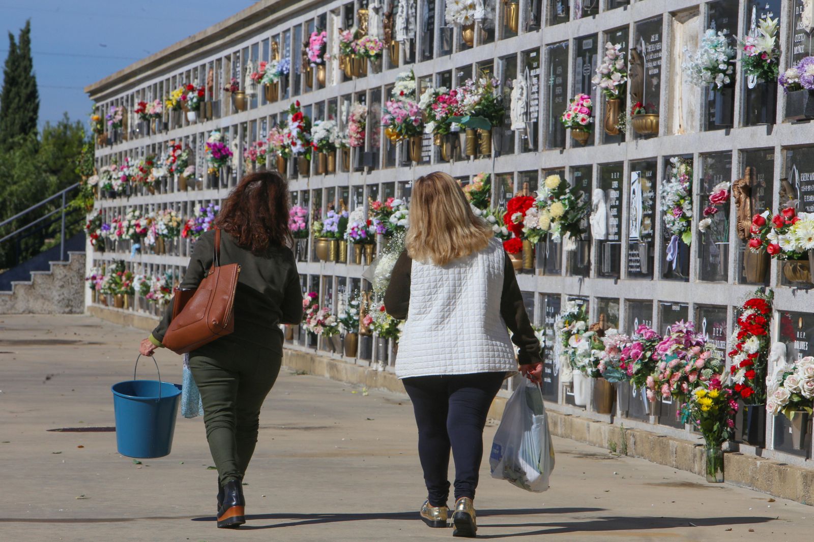 Familiares llevando ayer flores a sus seres queridos en el cementerio de Chiclana
