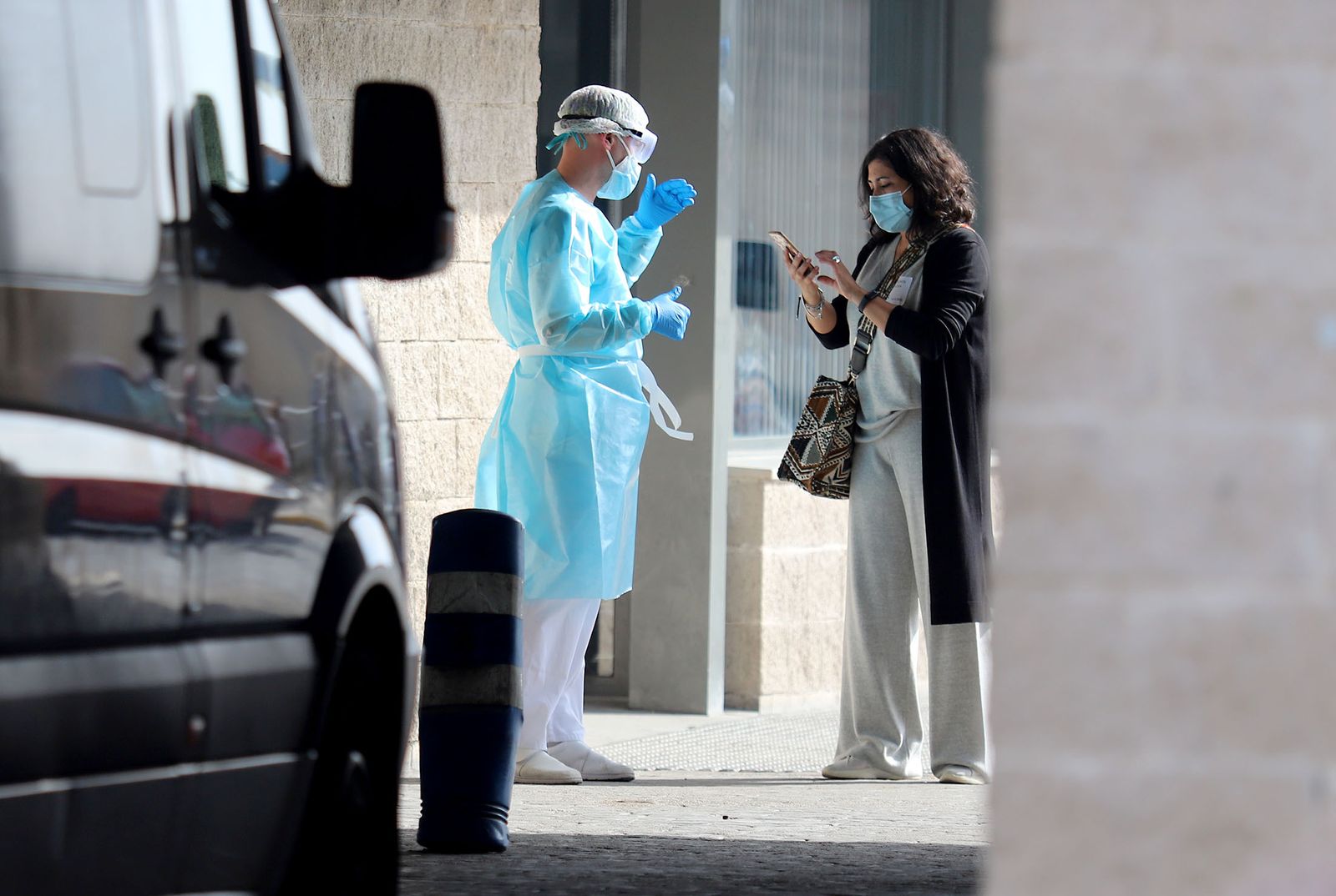 Un sanitario conversa con una mujer en el exterior del Juan Ramón Jiménez.