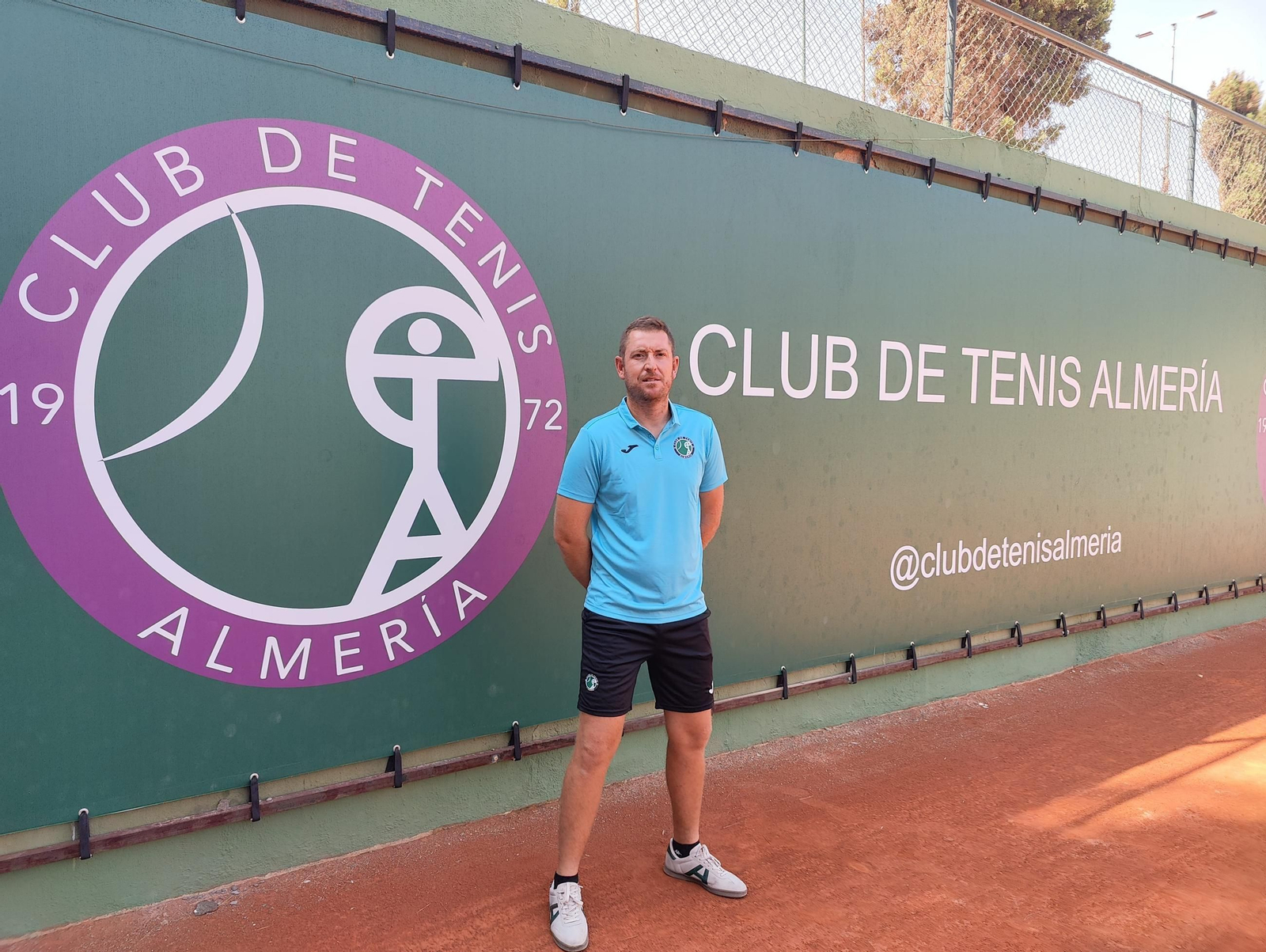 Alberto García Lara posa junto al escudo del club almeriense en sus instalaciones localizadas en Huércal de Almería.