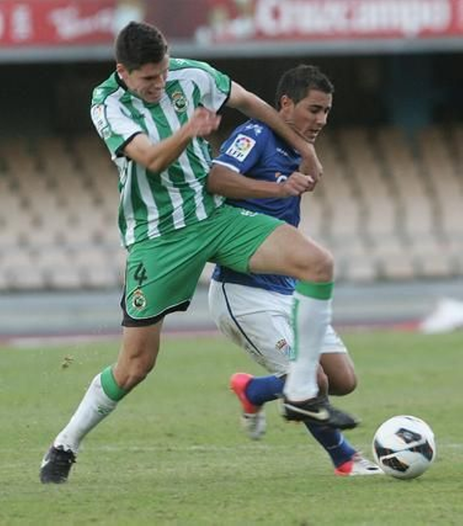 Un defensa del Racing trata de arrebatar el balón a un jugador azulón. / Pascual