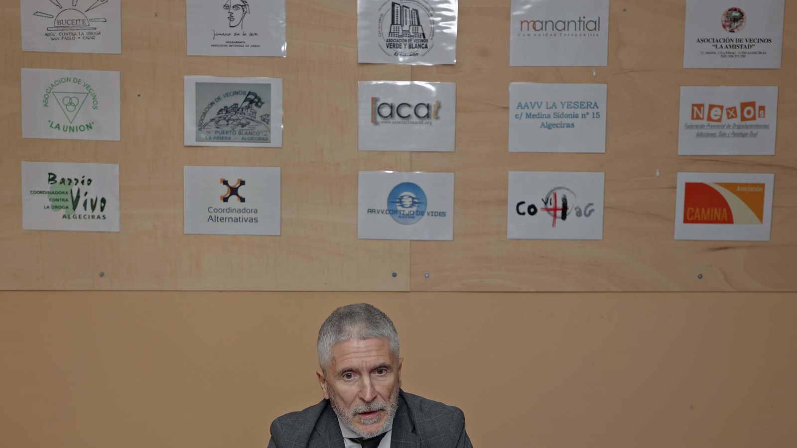 Fernando Grande-Marlaska, durante la entrevista, ante los carteles de diversos colectivos ciudadanos en la asociación de vecinos Los Toreros, en Algeciras.