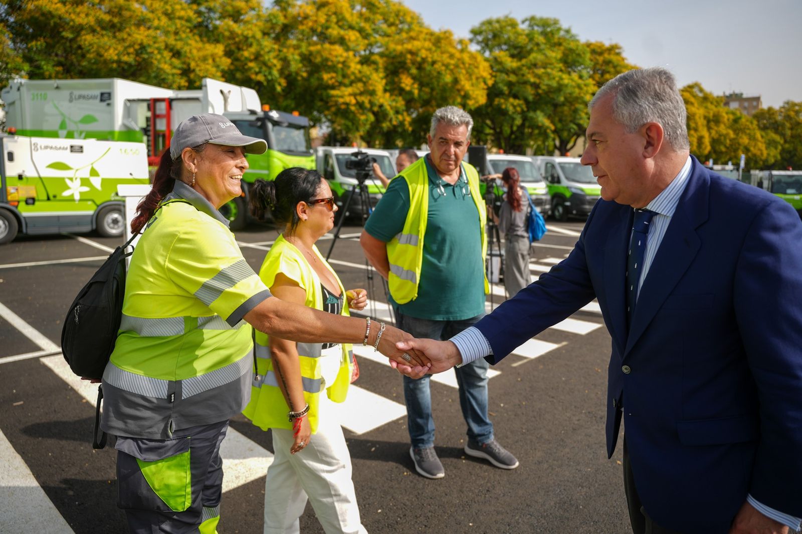 El alcalde saluda a empleados de Lipasam en el acto de presentación de los nuevos vehículos.