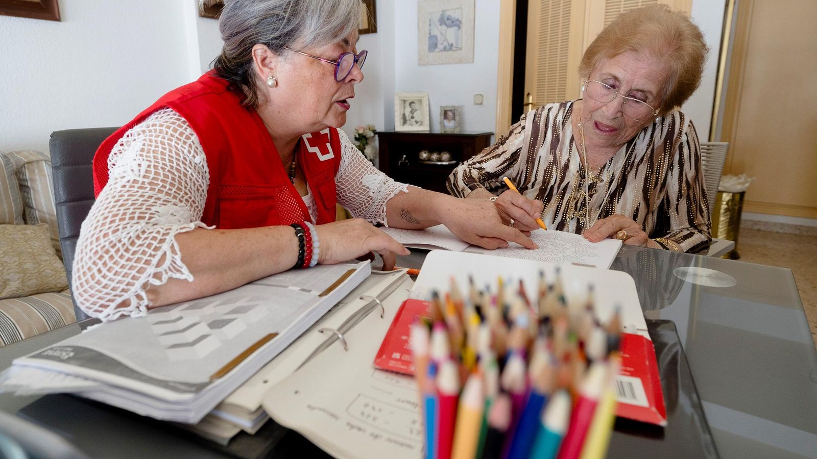 María Sevillano colorea una mandala en presencia de María Gil, que le sugiere los colores que puede usar.