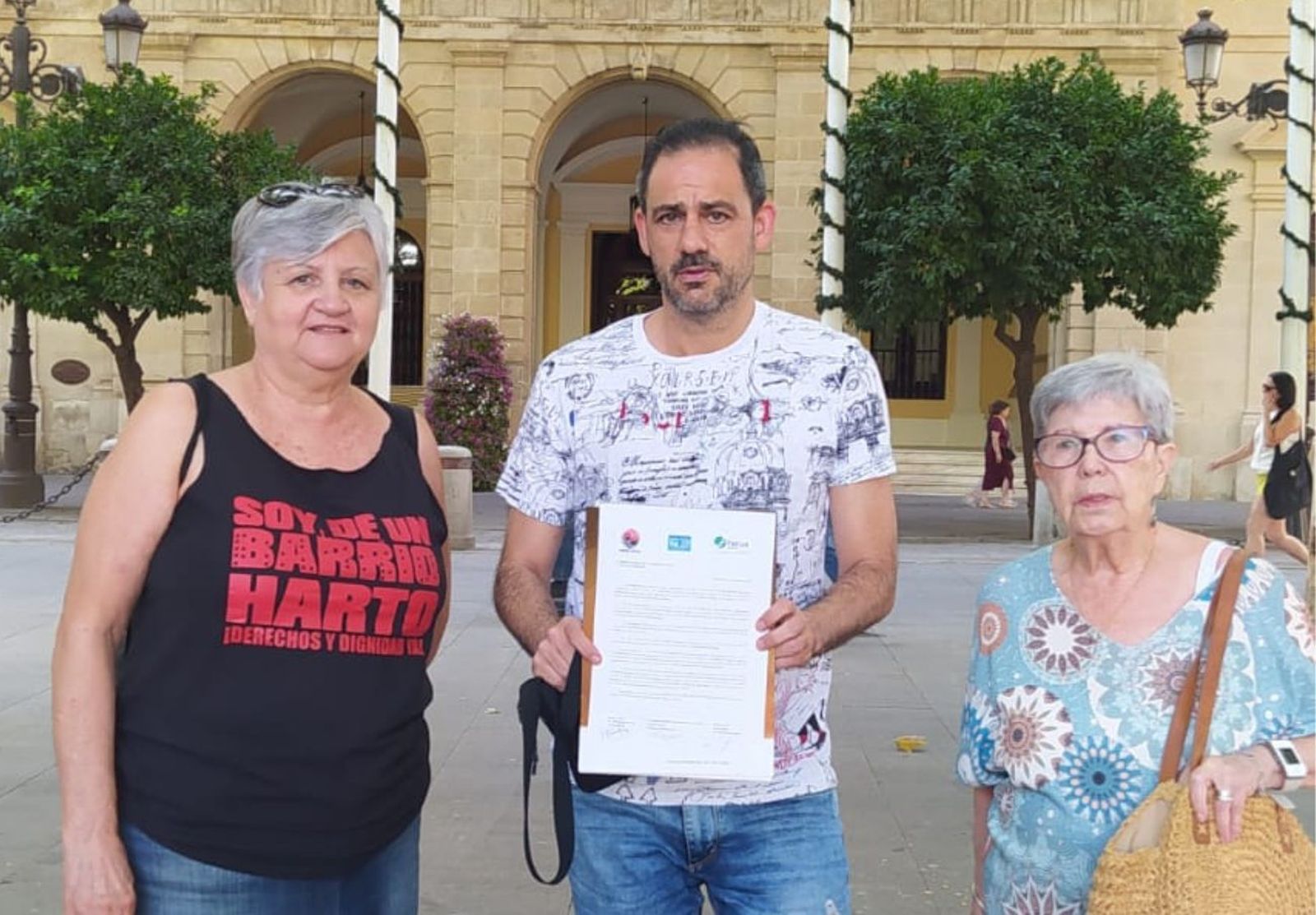 En el centro, Jordi Castilla, secretario general de FACUA Sevilla, junto a María del Carmen Priego, portavoz de Barrios Hartos, y Rosario García, portavoz de Nosotros también somos Sevilla.