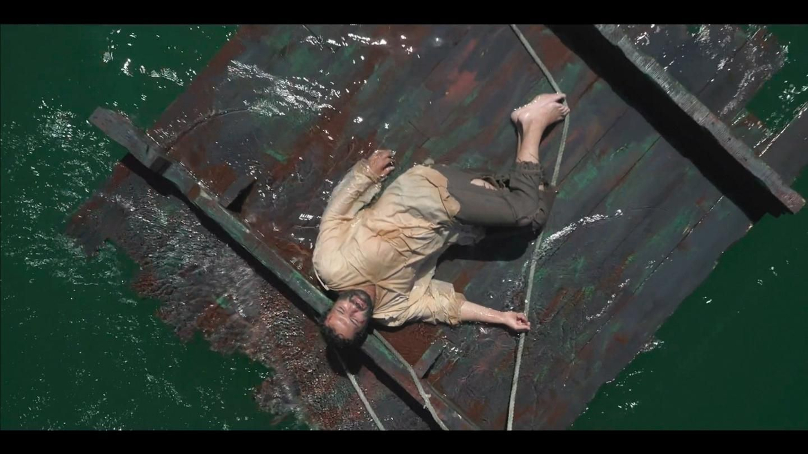 Fotograma de 'El prenauta', con el actor Alfonso Sánchez sobre unas maderas a la deriva en alta mar.