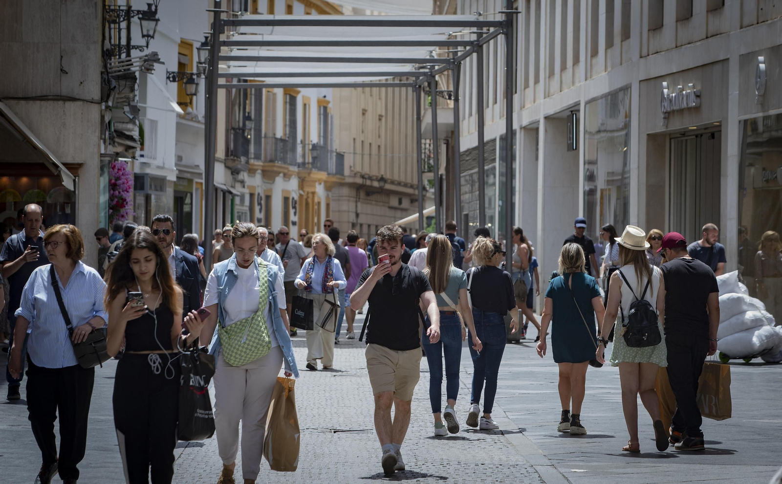 Personas pasean por la calle Tetuán, una de las principales arterias del centro de Sevilla.
