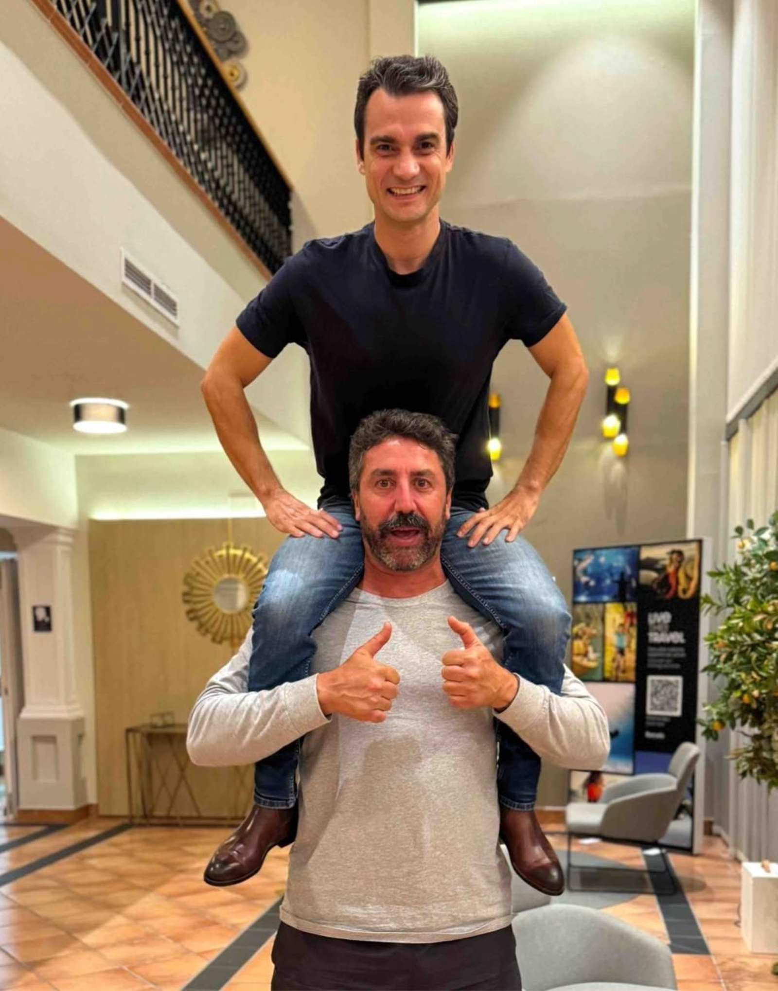 Pedrosa, como un torero, mostrando los botines a hombros de Raúl Cerro.