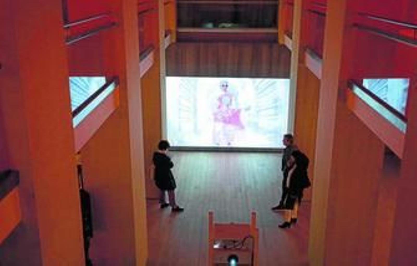 1. Aspecto de la sala de la Fundación Botín que acoge una de las obras centrales, donde puede verse a Jonas con gafas negras y gran chaqueta de papel. 2. Otra de las proyecciones con la que se relacionan los 'performers' reales. 3 y 4. Primer plano y plano medio de la artista (Nueva York, 1936).