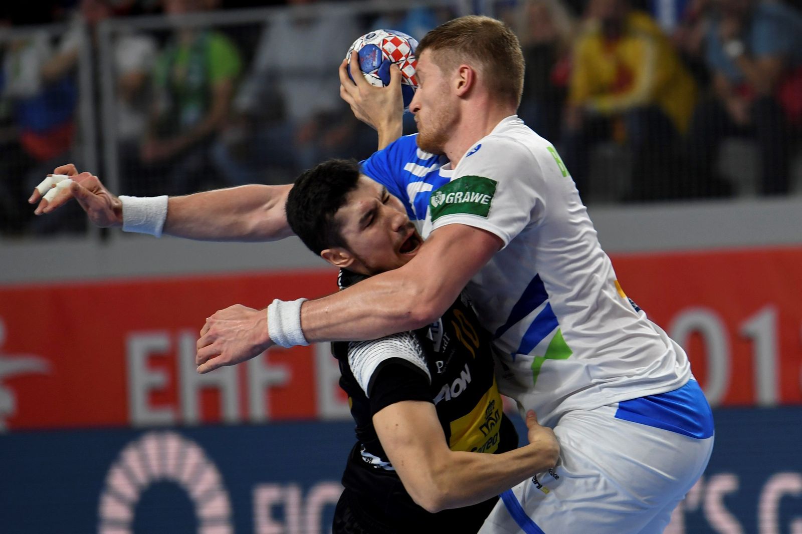 El pivote esloveno Blaz Blagotinsek defiende con contundencia al lateral español Álex Dujshebaev.