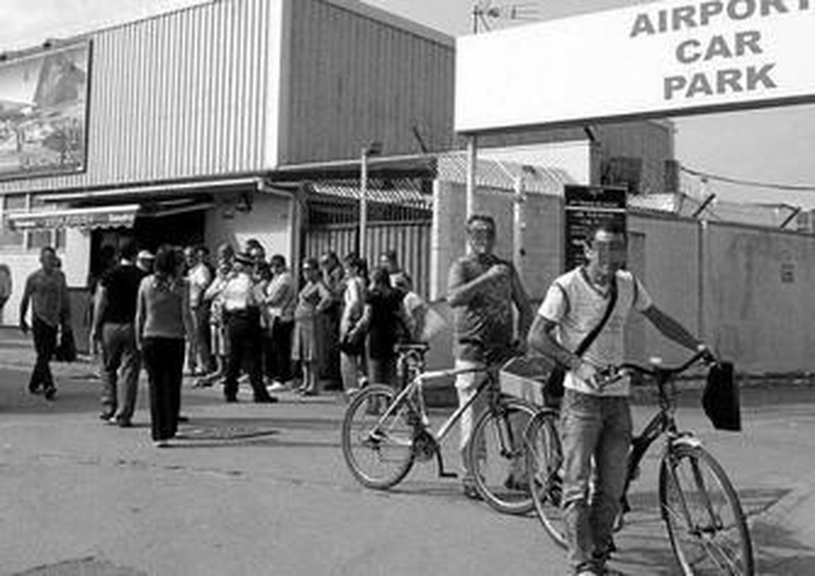 Una agente policial de Gibraltar ordena la cola de personas que esperan para comprar tabaco.
