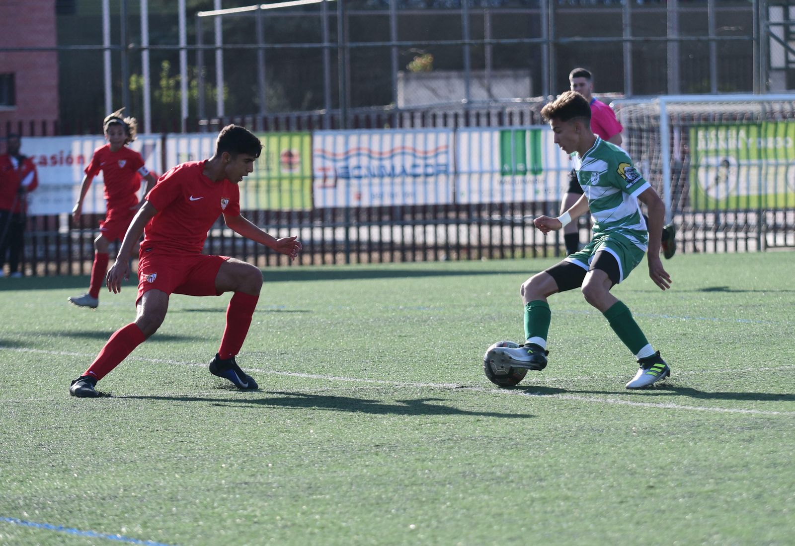 Un jugador del Juanín y Diego encara a un jugador del Sevilla.