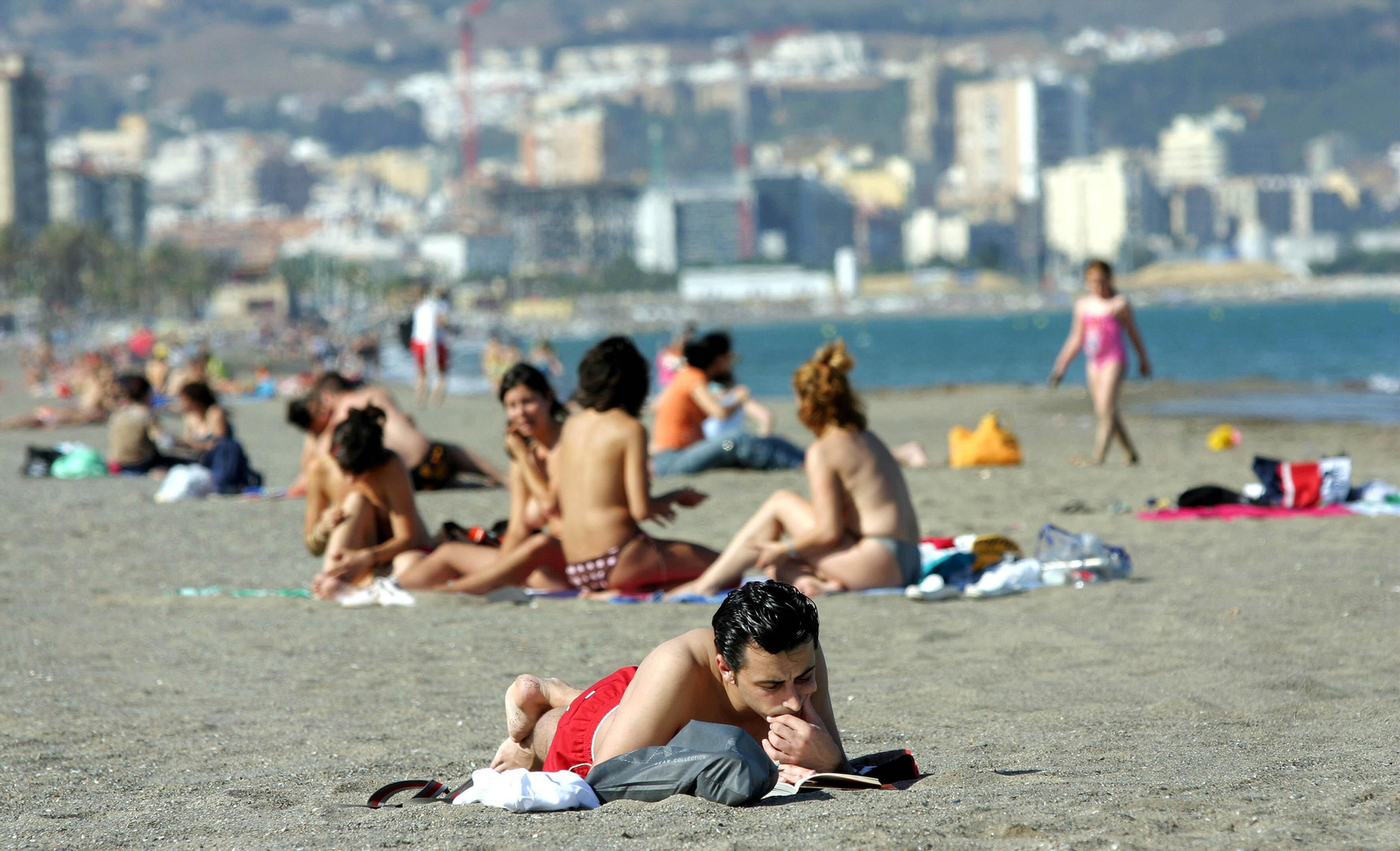 Un joven lee un libro en la playa de La Misericordia de Málaga. Un joven lee un libro en la playa de La Misericordia de Málaga.