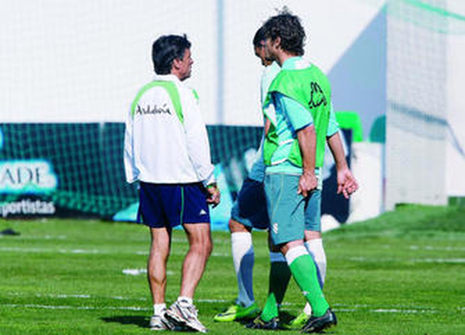 Edu dialoga con Chaparro, en presencia de Oliveira, mientras se toca el bíceps femoral izquierdo.