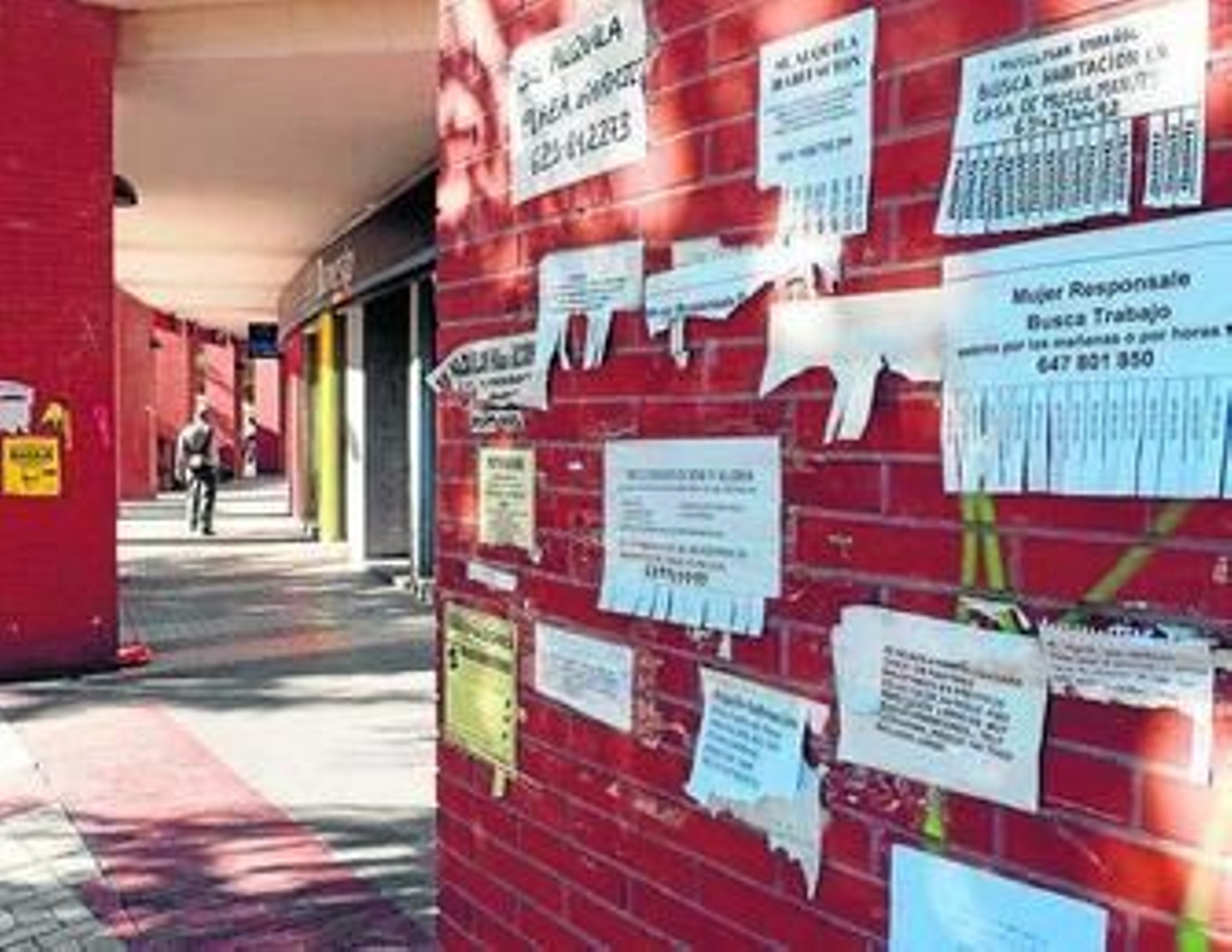 Anuncios con diverasas ofertas pegados en una pared.