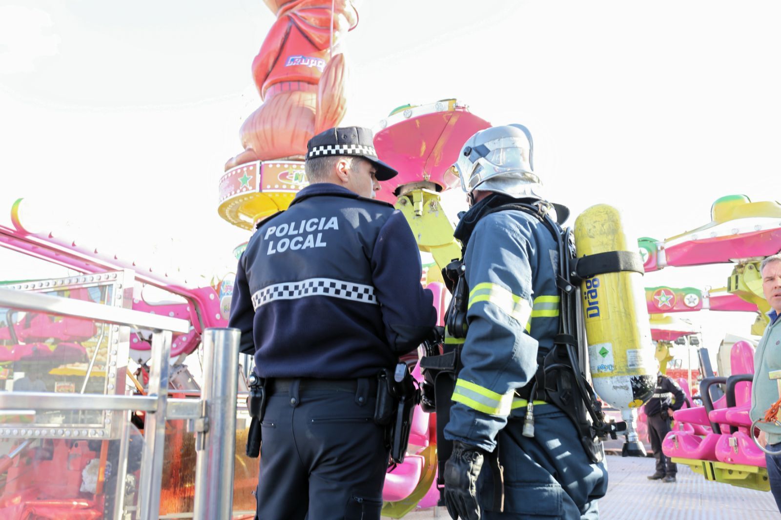 Un policía local y un bomberos, junto a la atracción.