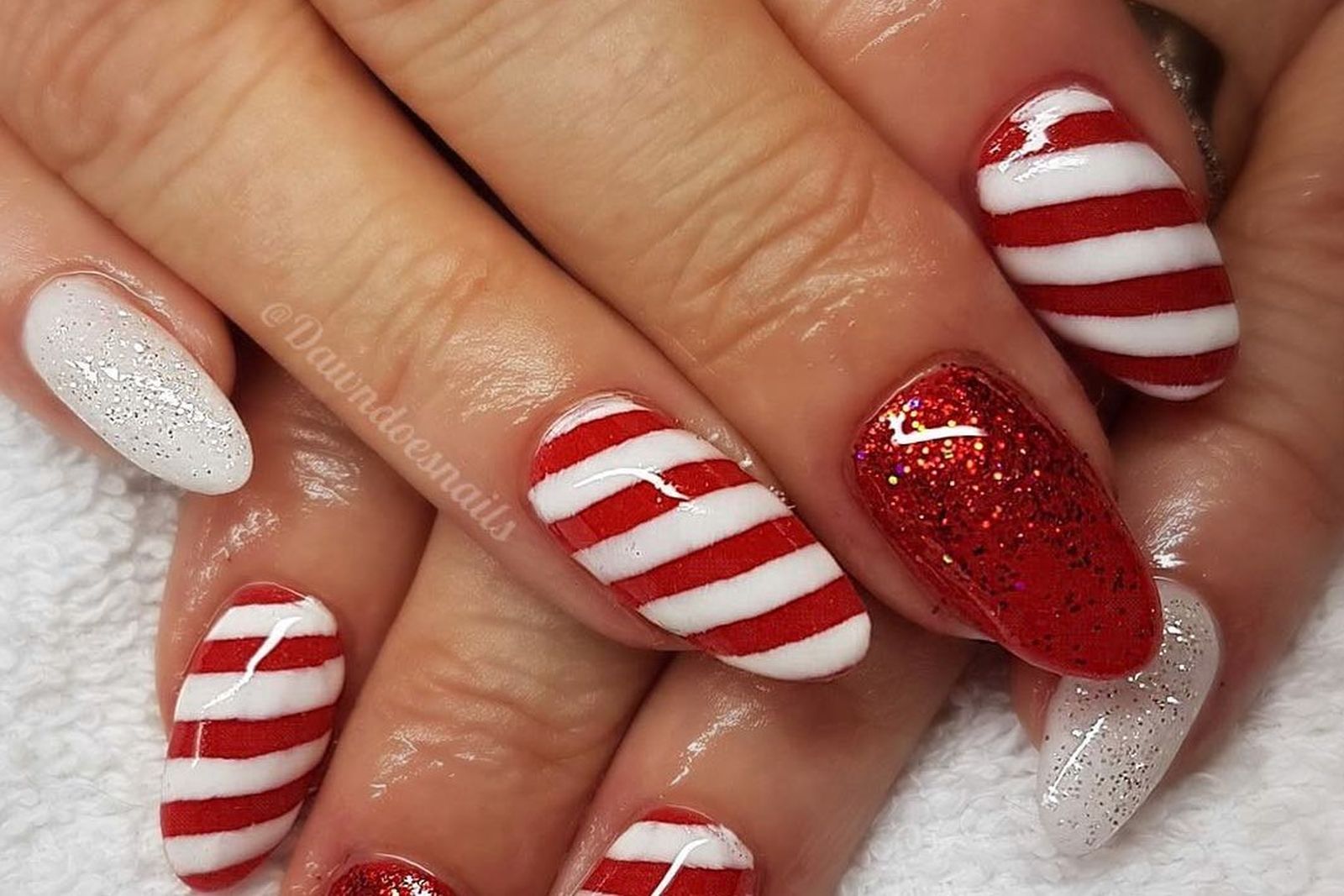 Manicura inspirada en los bastoncillos de caramelo tradicionales navideños de @dawndoesnails.