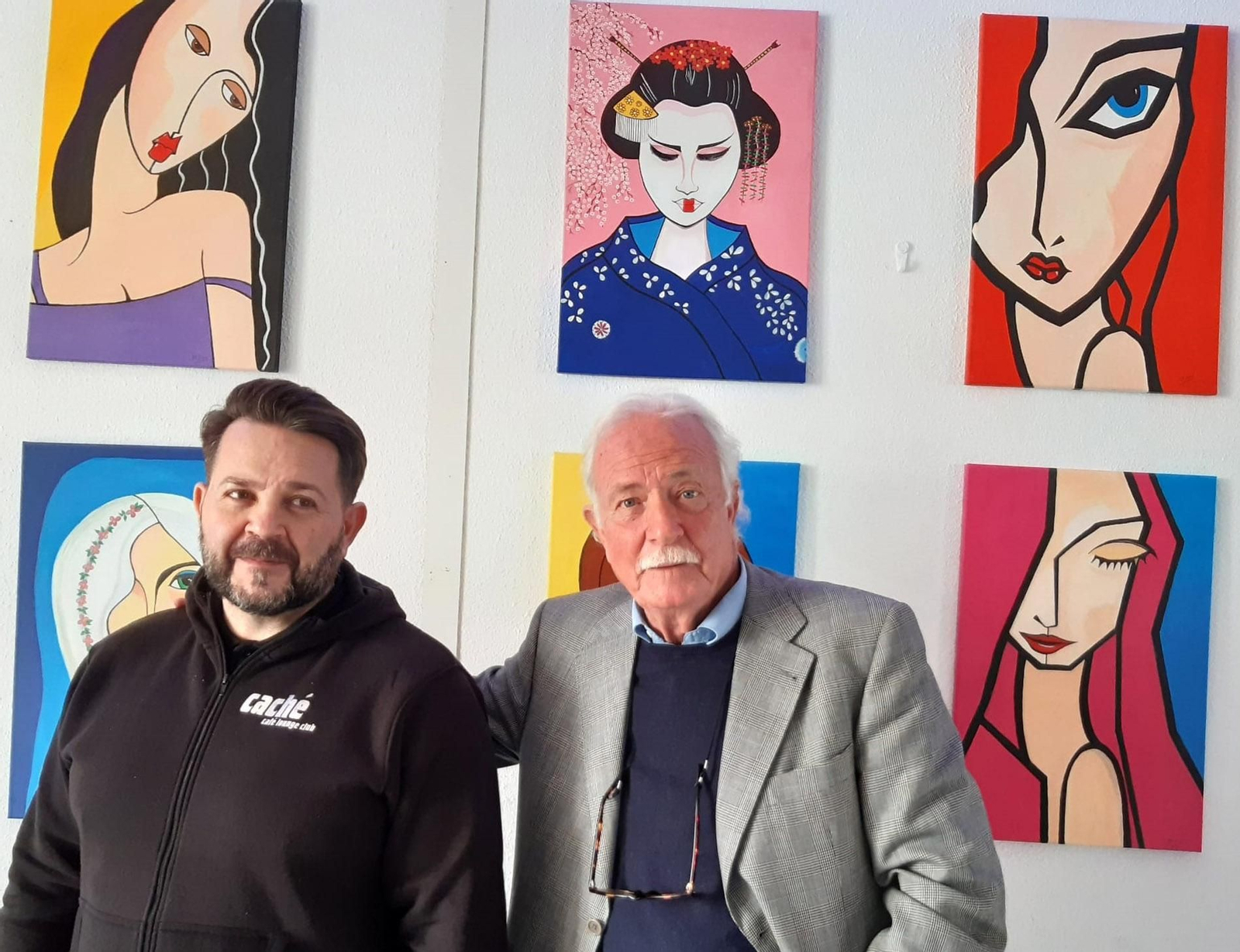 Pepe Salas (d), junto al propietario del espacio expositivo, con algunas de sus obras al fondo