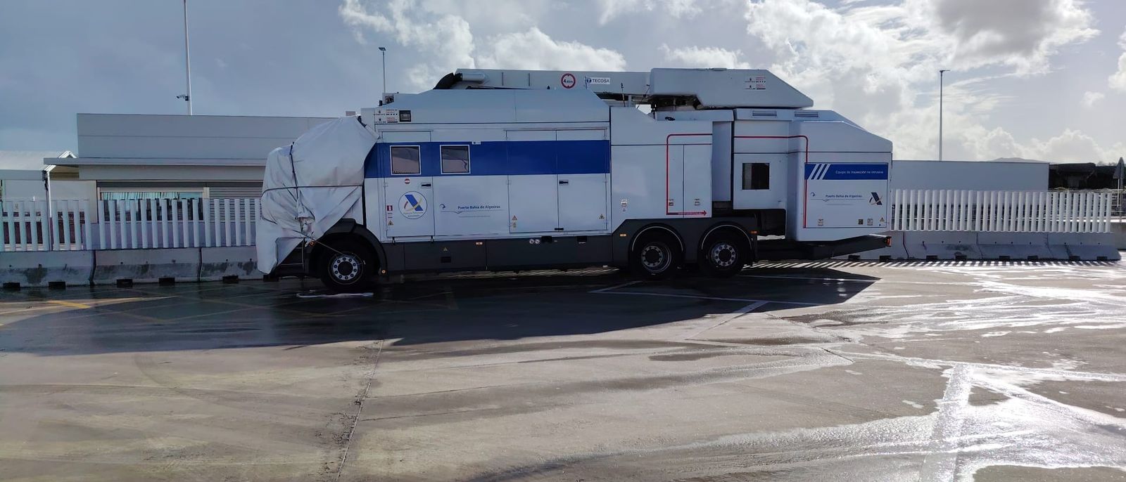 El camión aparcado, con su cabina cubierta por una lona impemeable blanca.