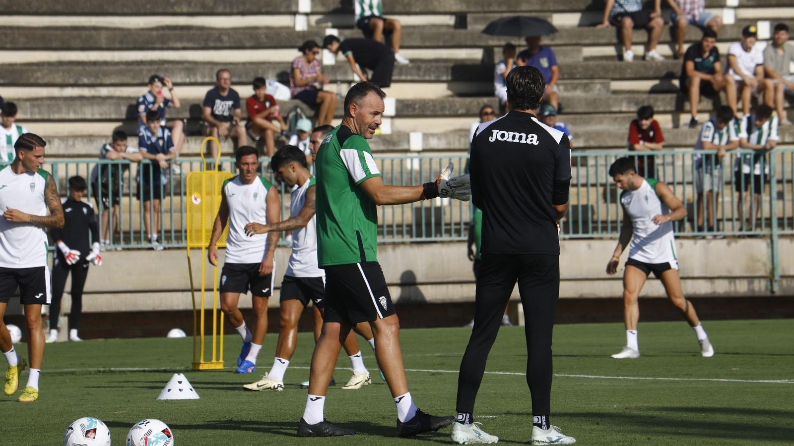 David Pérez, el nuevo entrenador de porteros del Córdoba CF, habla con Carlos Marín en el primer entrenamiento del verano.