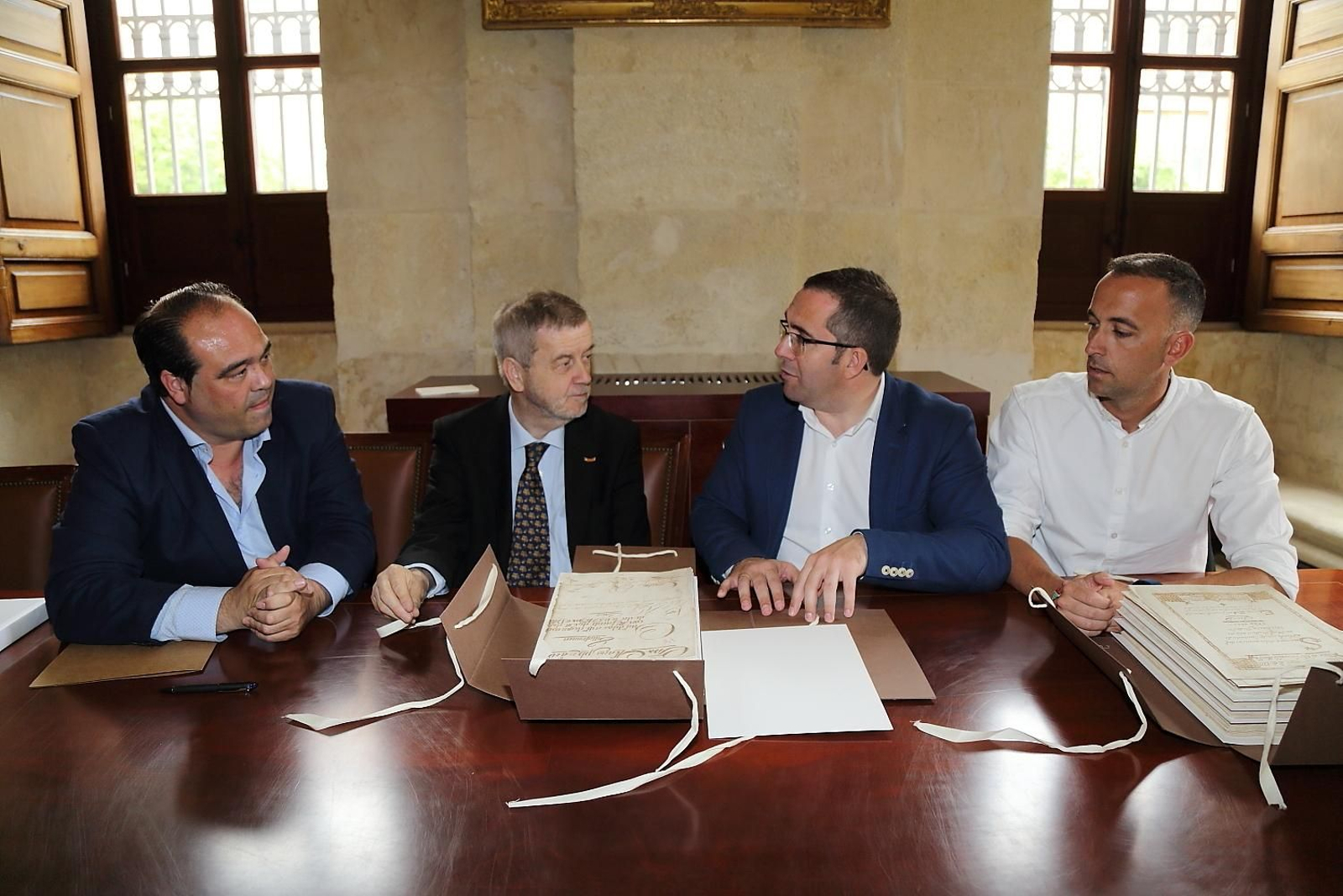 El director del Archivo de Indias, Manuel Ravina, entrega los legajos al alcalde, en presencia del archivero municipal y el edil de Cultura, en la sede de la institución.