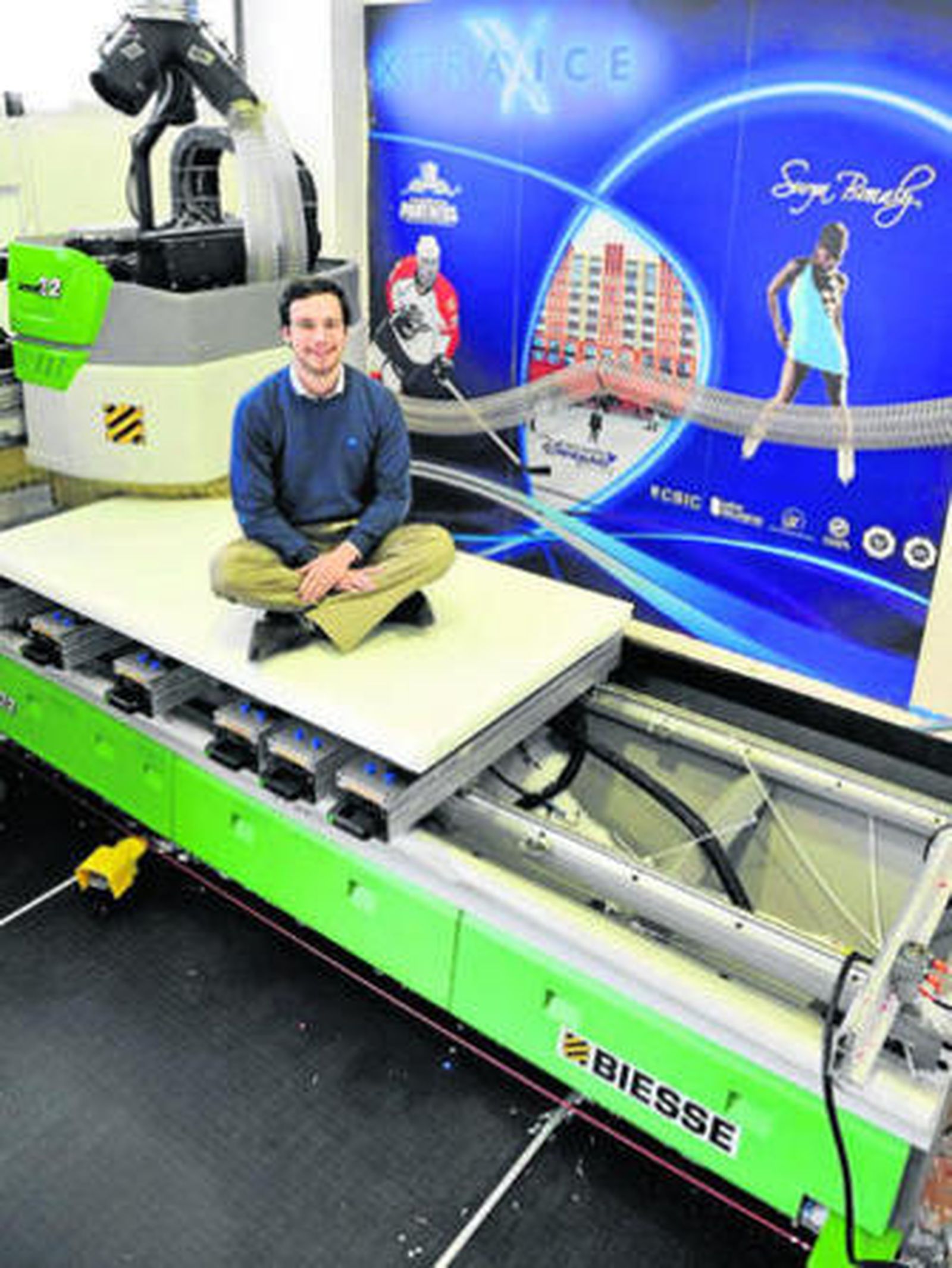Adrián Ortiz posa sobre una máquina que genera las planchas de hielo sintético.